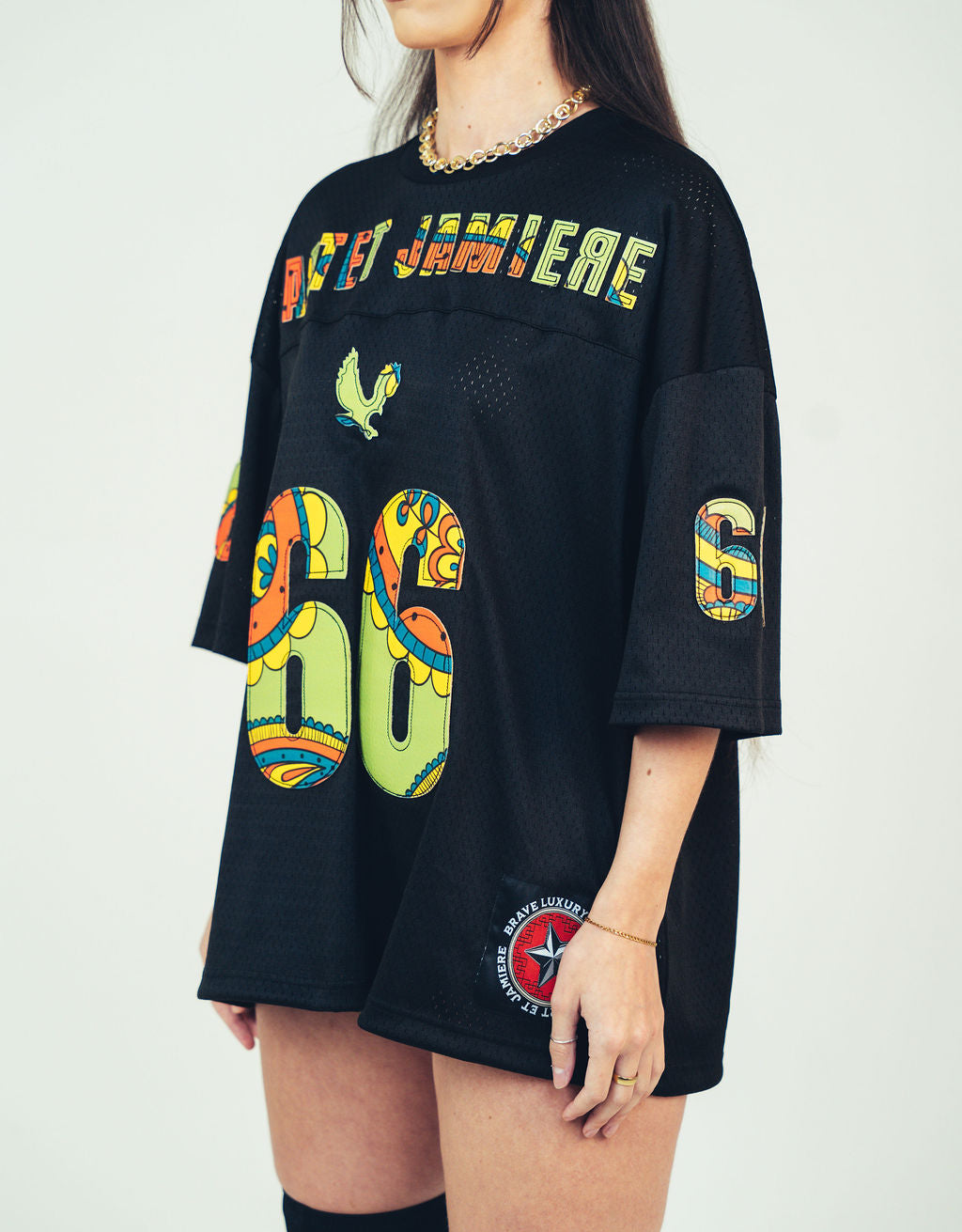 Black dress with colorful text and graphics on a plain background